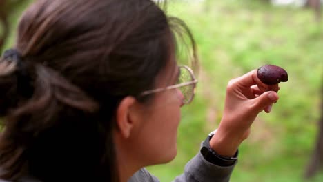 woman with boletus mushroom in forest