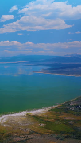 Mesmerizing turquoise scenery of lake joining with sky. Amazing saline soda Mono Lake in California from aerial perspective. Vertical video