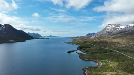 Road E10 runs along Austnesfjorden towards Svolvaer with mountains, fjord, and ocean horizon in view