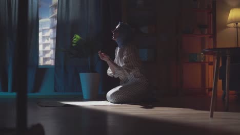 beautiful young muslim woman in hijab prays in the house