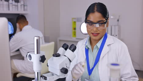 Tablet,-microscope-and-woman-scientist