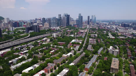 aerial rising shot of the petite-bourgogne district with downtown montreal in background