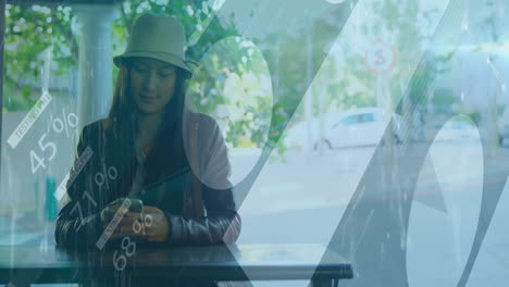 animation of infographic interface over smiling biracial woman wearing hat scrolling on smartphone