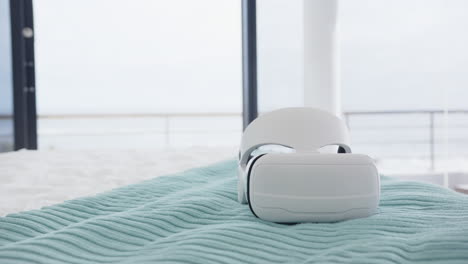 vr headset resting on spa bed with soft blue blanket in modern spa, at home, copy space