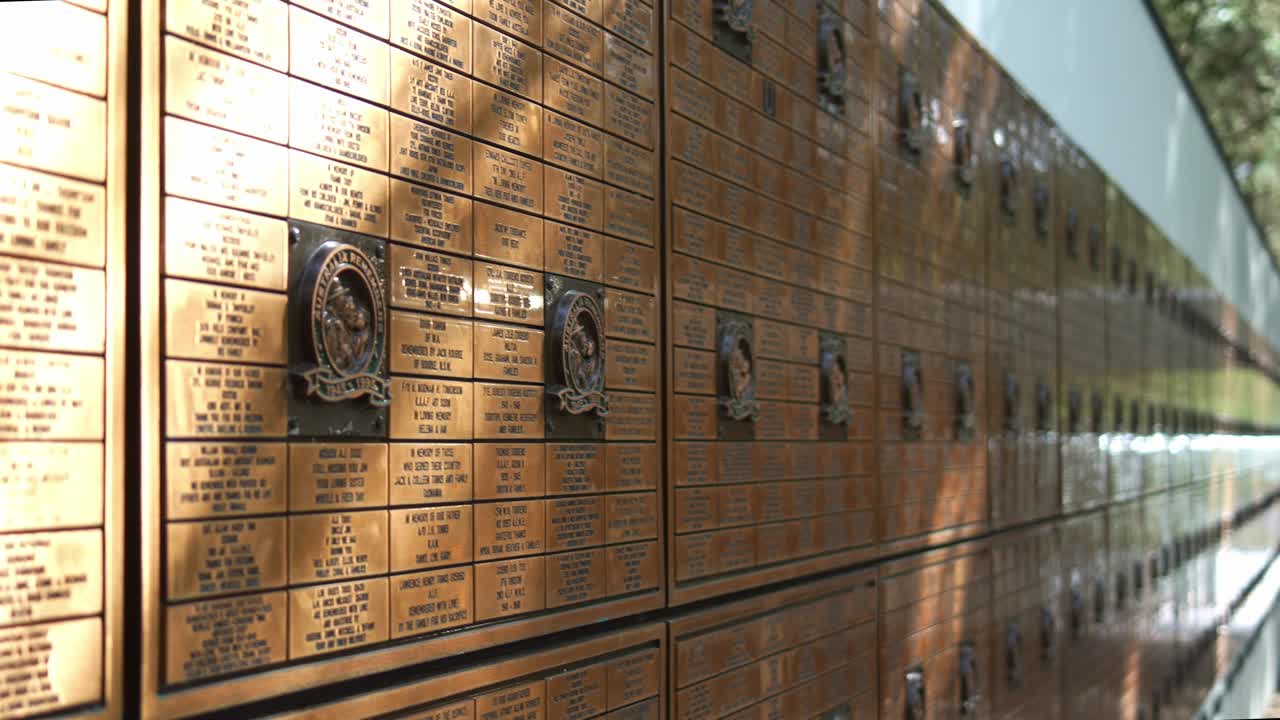 National Australia Remembers Freedom Wall with metal plaques on the wall, a Memorial park in Mount Coot-tha, Queensland, a space for quiet contemplation and reflection on the spirit of freedom.