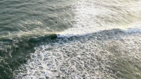 Aerial-View-Of-Surfers-Surfing-At-La-Pampilla-Beach-In-Miraflores,-Lima,-Peru