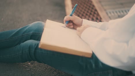 schoolboy tired of preparing for tests draws on book page