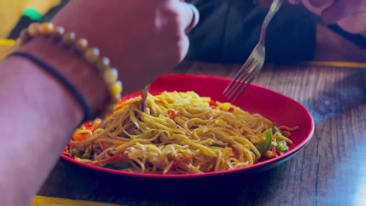 Tourists relish chow mein and sea buckthorn tea at Komic village in Spiti, India