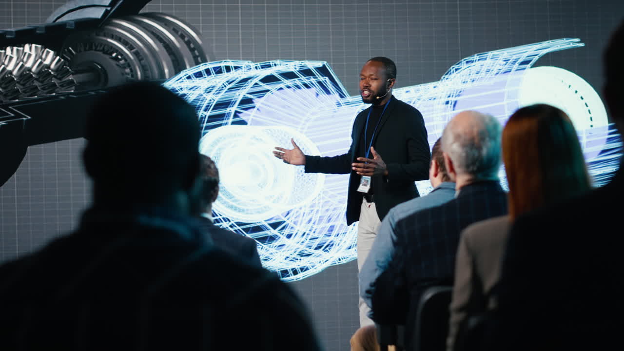 African american speaker does futuristic industrial presentation with a turbine