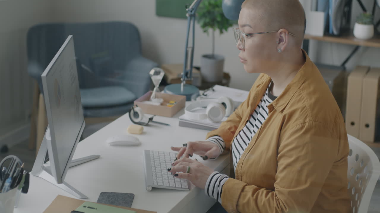 Woman Working at a Computer in a Home Office