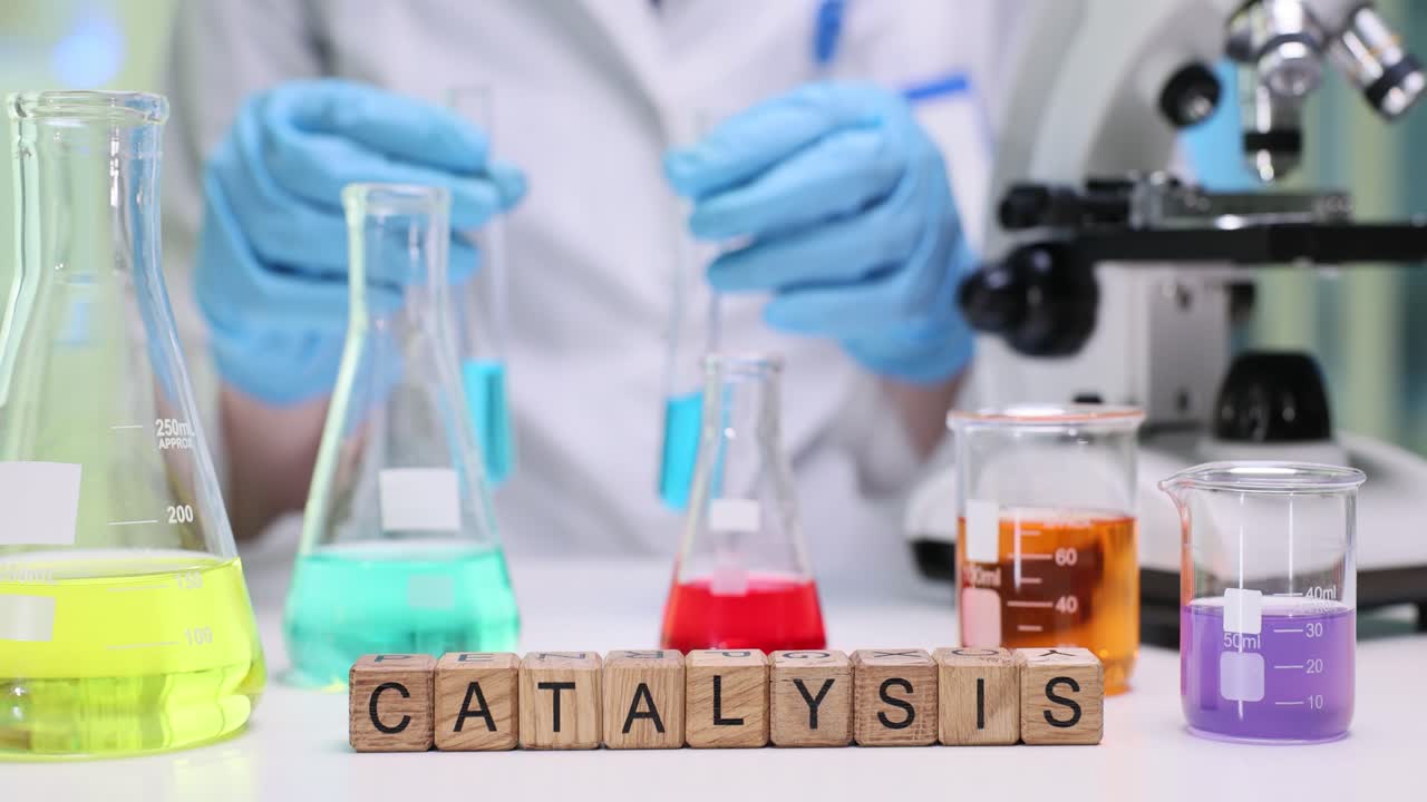 Scientist working in a chemistry lab with various solutions and equipment, focusing on catalysis