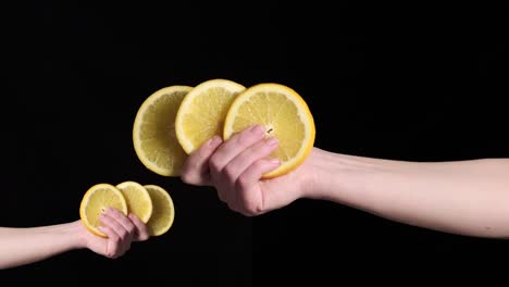 a woman's hand holds slices of ripe orange in her hand. next to the reflection.