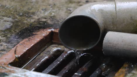 water pouring out of drain pipe into drain - 4k