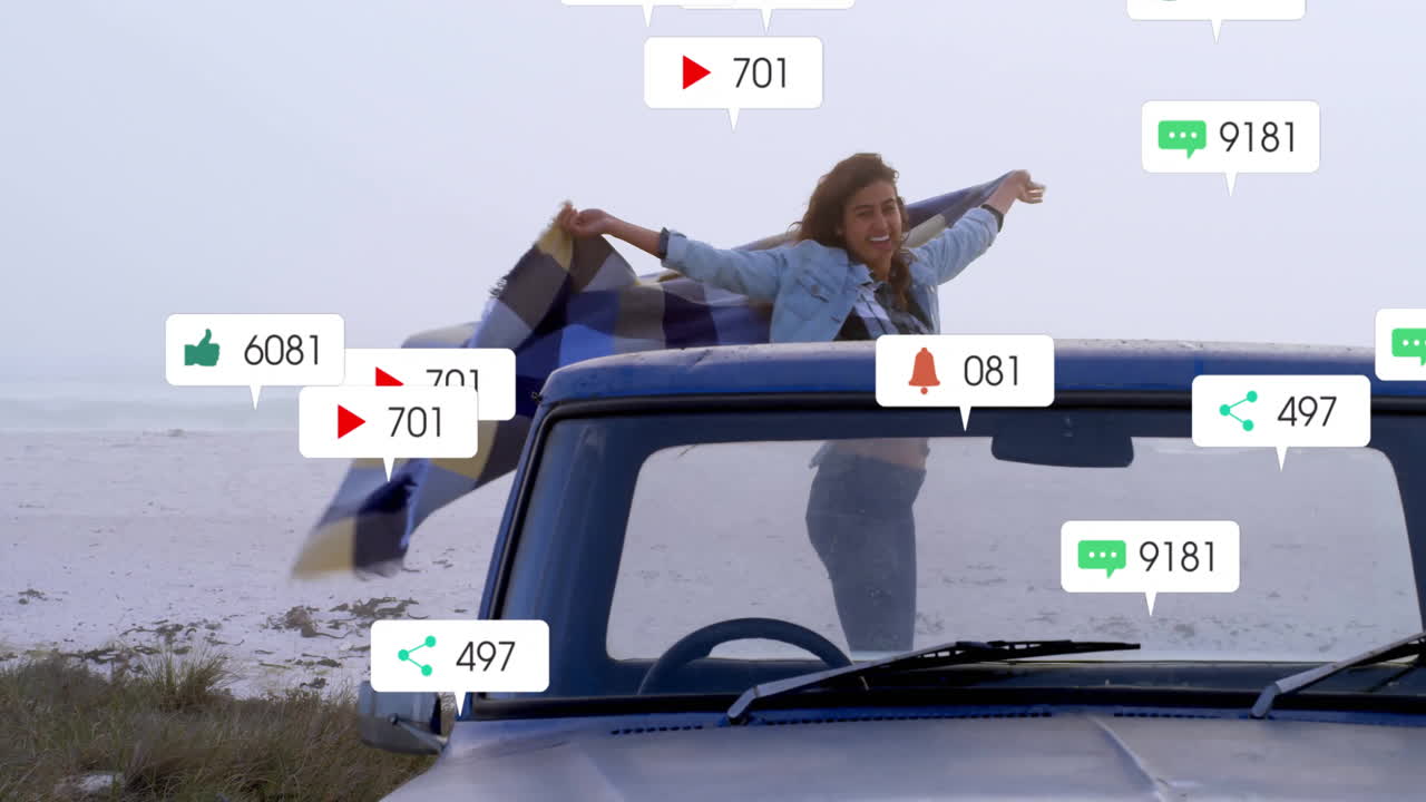 woman standing through sunroof of car on beach, with animated social media marketing icons floating