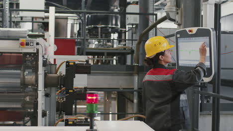 female engineer adjusting electronic equipment