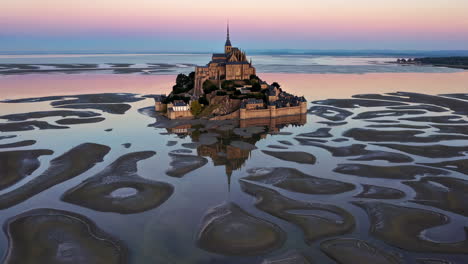 mont saint-michel at sunrise/sunset with low tide reflection