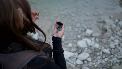 woman hiking with compass in nature