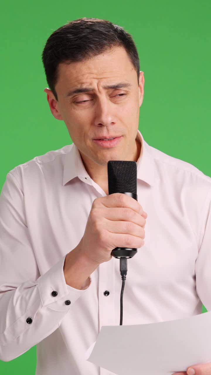Man with microphone in hand giving a speech
