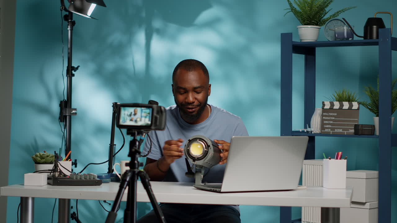 African american blogger reviewing studio light on camera