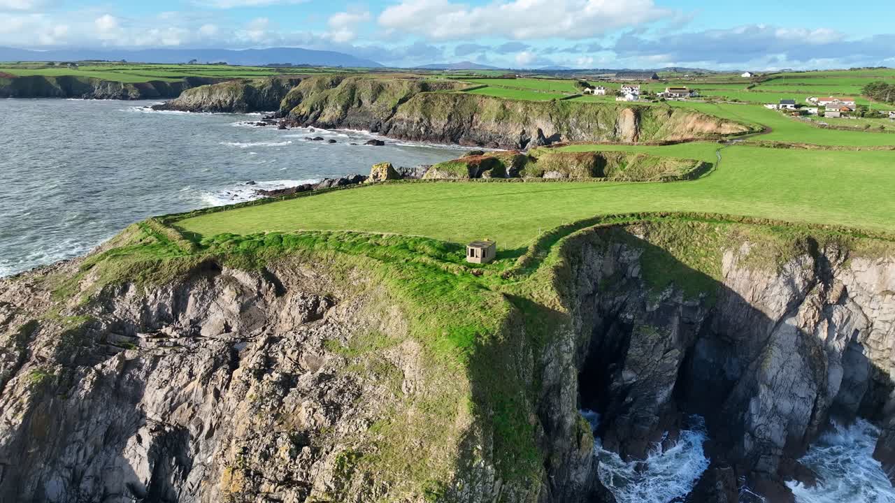 Waterford Epic Locations Dunabrattin Head Copper Coast WW 2 lookout Hut and waves crashing into sea caves storm in winter