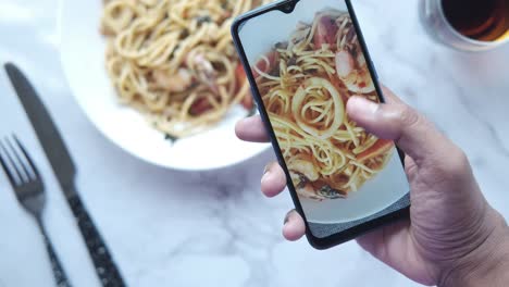 taking a picture of delicious spaghetti with shrimp