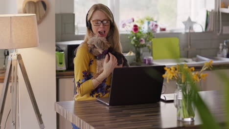 woman on video call with dog in kitchen