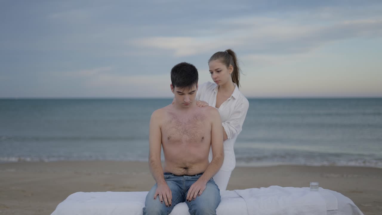 Couple enjoying a relaxing shoulder massage on the beach