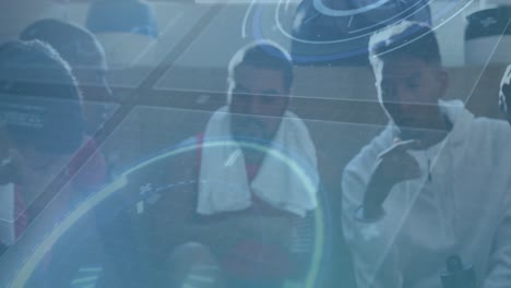 animation of interface processing data over diverse male sports team talking in dressing room