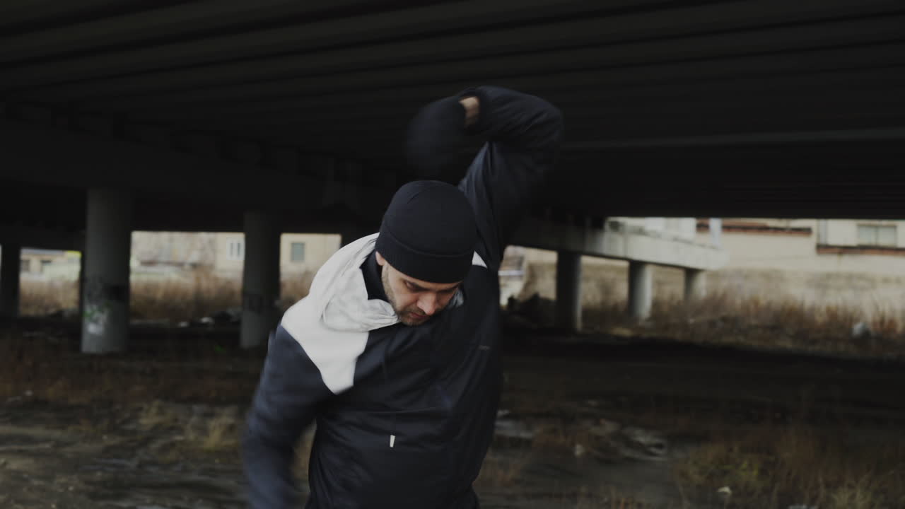 Man exercising under a bridge in urban environment