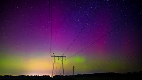 Glowing-northern-lights-aurora-borealis-with-transmission-tower-line-in-the-foreground---time-lapse