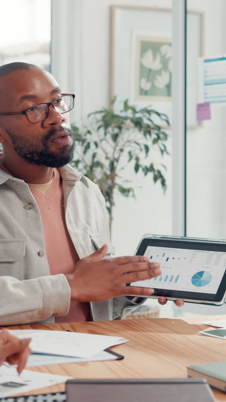 Black Man Presenting Data on Tablet in Office Meeting