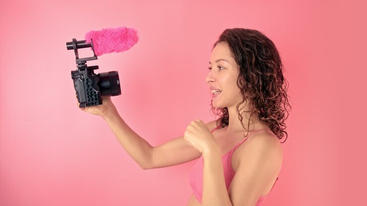 Donna che fa vlogging con telecamera e microfono