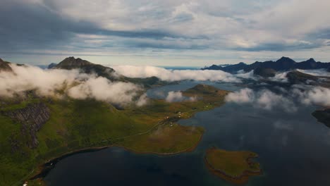lofoten islands, norway. flying through clouds and scenic coastal landscape with green mountains and blue sea