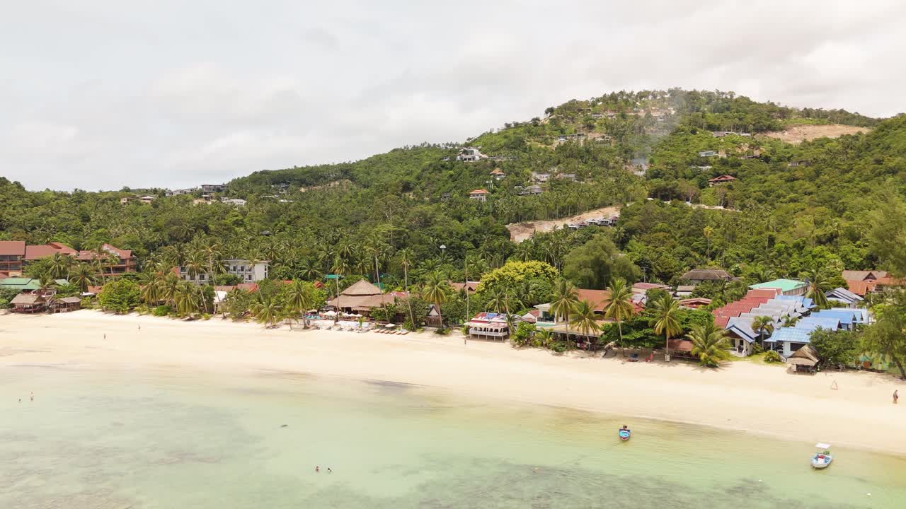 Relaxing beach scene at Haad Yao in Ko Pha Ngan with golden sand and palm trees