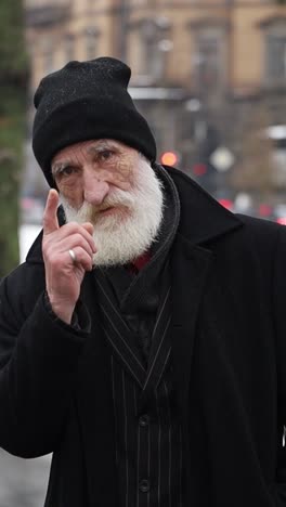 portrait of an elderly man with a white beard in winter clothing
