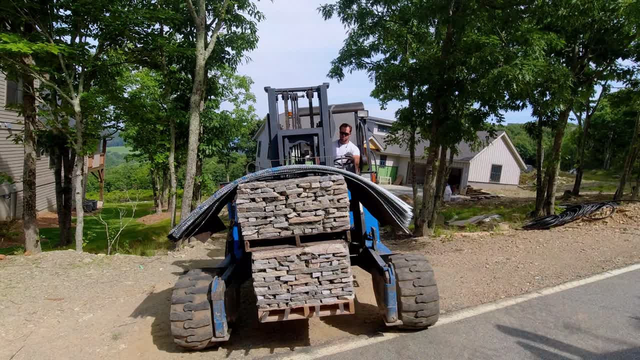 Pallets of Stone Unloaded by forklift at construction site