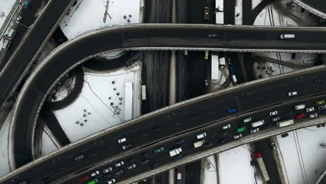 car traffic on highway junction in winter city. top view car jam on freeway