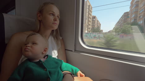 baby girl traveling with mum by train