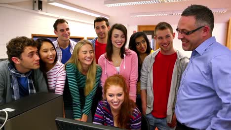 Computer-lecturer-pointing-something-out-to-his-class-on-the-screen