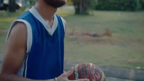 young handsome basketball player training outside