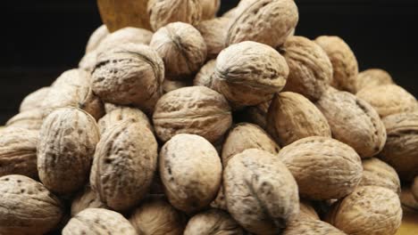 a pile of walnuts lies on a board