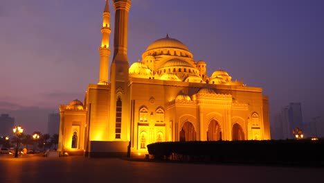 slow motion: track to al noor mosque. night shot illuminated building of mosque.