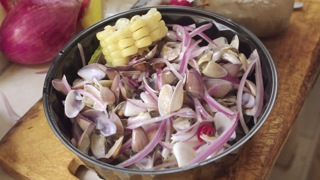 Delicious Peruvian ceviche dish of shells or Palabritas, onion and corn