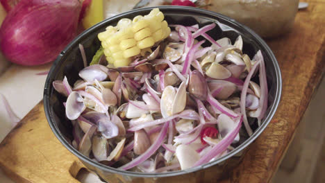 Delicious-Peruvian-ceviche-dish-of-shells-or-Palabritas,-onion-and-corn