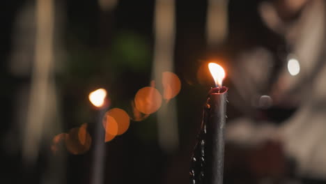 burning candles in a dark setting