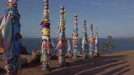 Shaman-Rock-totem-poles-on-clifftop-at-Cape-Burkhan,-Olkhon-Island,-Lake-Baikal