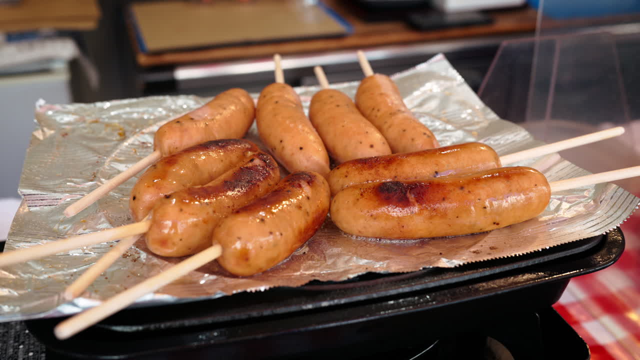 Close up of sausages on skewers flying at the Tsukiji Fish Market in Japan