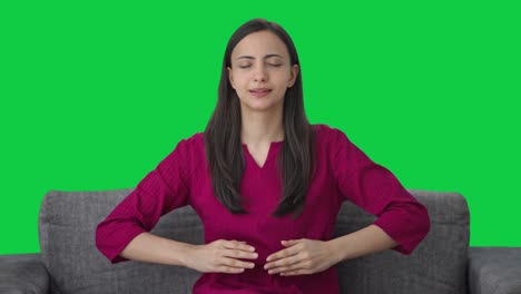 Happy-Indian-woman-doing-breathe-in-breathe-out-exercise-Green-screen