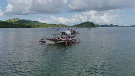 Drone-Shot-Flying-Towards-Fishing-Boats-in-Surigao-Del-Norte,-Philippines