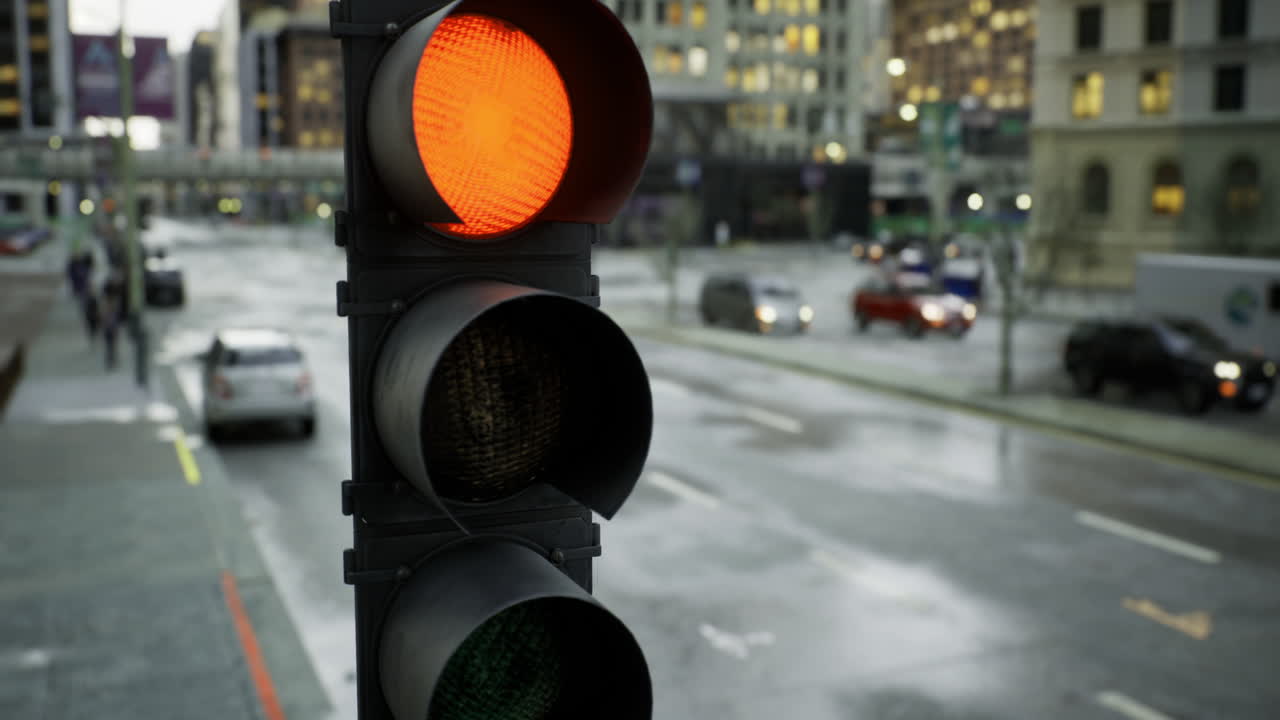 Traffic light signals caution during a rainy evening in a bustling city